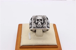 Detailed shot of retro punk skull ring with rose floral engraving on stainless steel