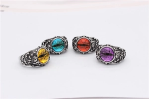 Detailed view of gothic punk eyeball rings in yellow blue red and purple stones