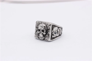Macro detail of retro punk skull ring with embossed rose pattern and vintage steel finish