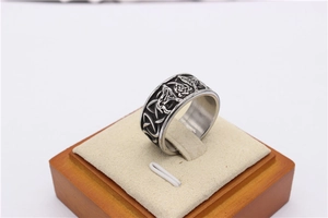 Macro detail of Nordic Viking wolf totem and Celtic knot patterns on a vintage steel ring