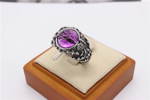 Macro view of vintage bat ring featuring a purple dragon eye stone and bone texture