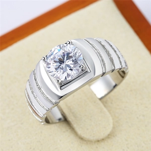 Detail of a men's silver ring featuring a round solitaire stone in a secure 4-prong setting