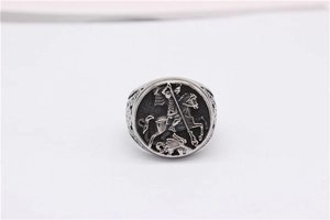 Macro shot of vintage knight shield ring featuring Saint George and the Dragon engraving
