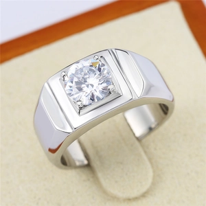 Macro shot of silver men's solitaire wedding ring with a clear round-cut cubic zirconia
