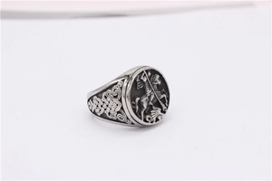 Macro detail of vintage Saint George and the Dragon knight signet ring with Celtic knots