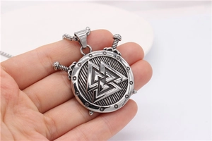 Detail of Viking Valknut shield pendant with crossed daggers on stainless steel chain