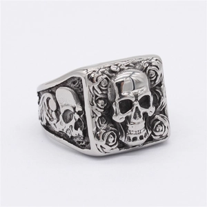 Vintage punk skull and rose stainless steel ring for men displayed at a 45-degree angle