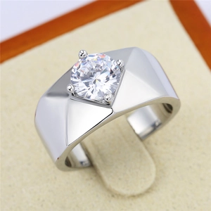 Macro shot of a men's geometric silver ring with a large round cut center stone in a box