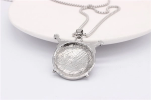 Detailed view of silver viking triangle pendant with textured back on round metal chain