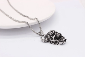 Close-up of gothic bull skull pendant with vintage textures on a silver box chain