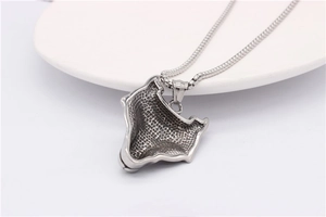 Detailed back view of wolf head steel pendant showing honeycomb texture and square chain