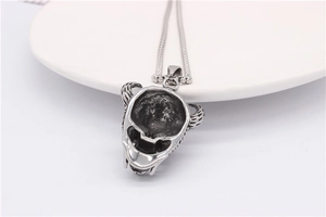 Detail of bull skull pendant showing hollowed-out back and fine metal bead chain link