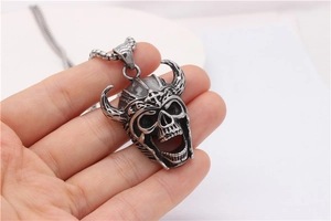 Macro view of vintage stainless steel skull pendant with horned helmet and metal chain