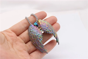 Detailed macro view of iridescent rainbow angel wing pendant on silver square pearl chain