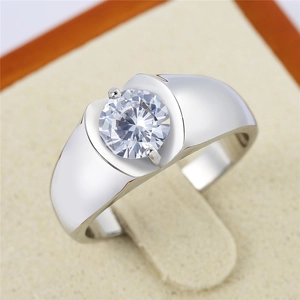 Macro view of men's silver wedding ring featuring a large round brilliant-cut stone