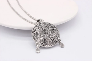 Detailed relief of Viking style crows and world tree on vintage silver pendant necklace