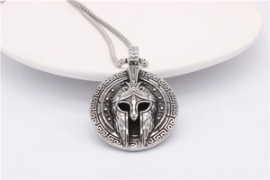 Detailed macro of vintage Spartan helmet pendant with Greek key pattern on steel chain