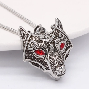 Retro punk wolf head pendant necklace with red eyes and celtic carvings on white background