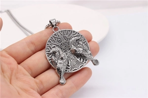 Macro detail of silver Viking necklace featuring a Yggdrasil tree and twin ravens engraving
