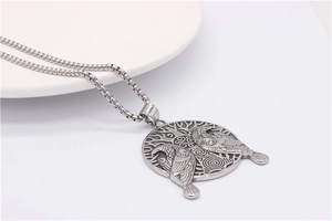 Detail of Viking tree of life pendant with symmetrical ravens on a silver box chain