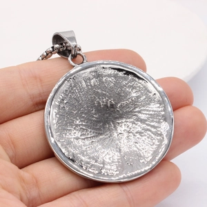 Vintage stainless steel zodiac compass pendant with meteorite texture on a box chain