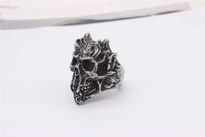 Close-up of gothic skull ring with vintage silver finish and intricate flame textures