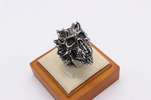 Close-up of vintage silver skull ring with gothic details and oxidized finish