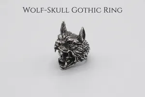 Macro shot of punk wolf head and skull ring with detailed vintage silver engraving