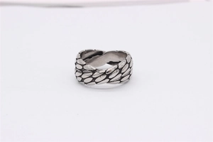 Macro view of vintage silver steel ring featuring unique overlapping scale textures