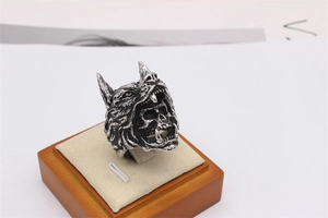 Macro detail of gothic wolf head and skull punk ring in retro vintage silver steel