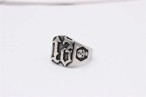 Détail d'une bague punk vintage avec tête de mort et chiffre 13 en finition argent oxydé