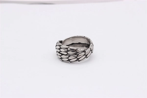 Detailed view of retro silver titanium ring with intricate dragon scale texture engraving