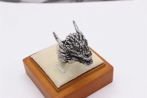 Close-up of vintage dragon head ring showing detailed scales and blackened finish