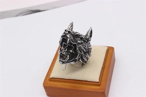 Detailed side view of vintage wolf head and skull punk ring made of titanium steel
