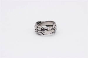 Detailed close-up of retro stainless steel ring with intricate scale texture and X-design