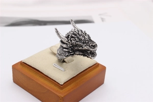 Close-up of vintage dragon head ring in silver finish with gothic oxidized details