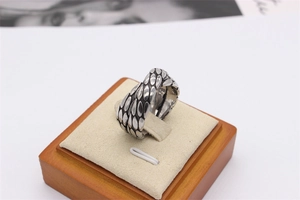 Macro shot of retro dragon scale textured stainless steel ring with oxidized finish