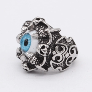 Gothic men's titanium steel ring with blue devil eye and skull carvings on white background