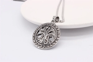Macro detail of Tree of Life pendant with Viking runes in antique silver finish