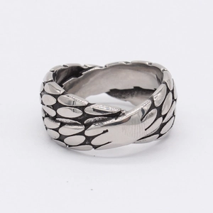 Retro stainless steel cross ring with embossed scale texture on white background