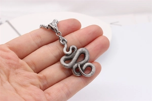 Macro view of vintage snake pendant with intricate scales and antique silver finish
