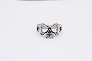 Macro detail of retro skull mask ring with intricate stainless steel carvings and textures