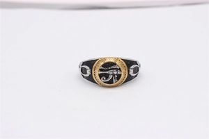 Macro detail of men's Eye of Horus ring with silver finish and gold-tone inlay
