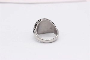 Macro detail of vintage silver steel ring with intricate hollowed side patterns
