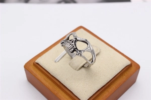 Detailed macro view of retro skull mask ring in titanium steel on a velvet display stand