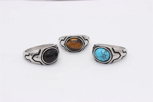 Detailed close-up of retro titanium steel men's rings with agate, turquoise and tiger eye stones