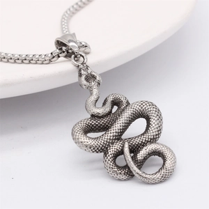 Retro snake pendant necklace in vintage steel finish with detailed scales on white tray