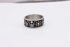 Détails des symboles de l'œil d'Horus et de l'Ankh gravés sur la bague en acier