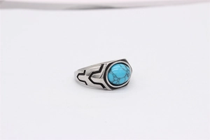 Detailed macro view of vintage titanium steel ring with blue turquoise and black totems