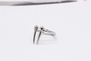 Detail view of a silver punk-style titanium steel ring featuring two symmetric sharp spikes
